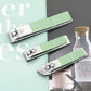 Three green nail clippers on a magazine page with blurred background